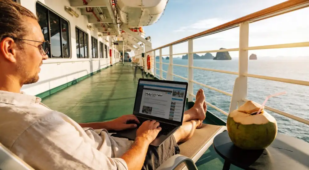 A-laptop-and-a-cold-coconut-sit-on-a-small-table