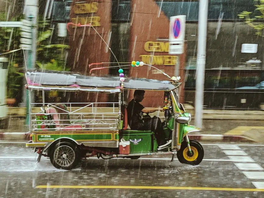 A Colorful Tuk Tuk Navigating The Rainy Streets Of Bangkok Thailand Sh
