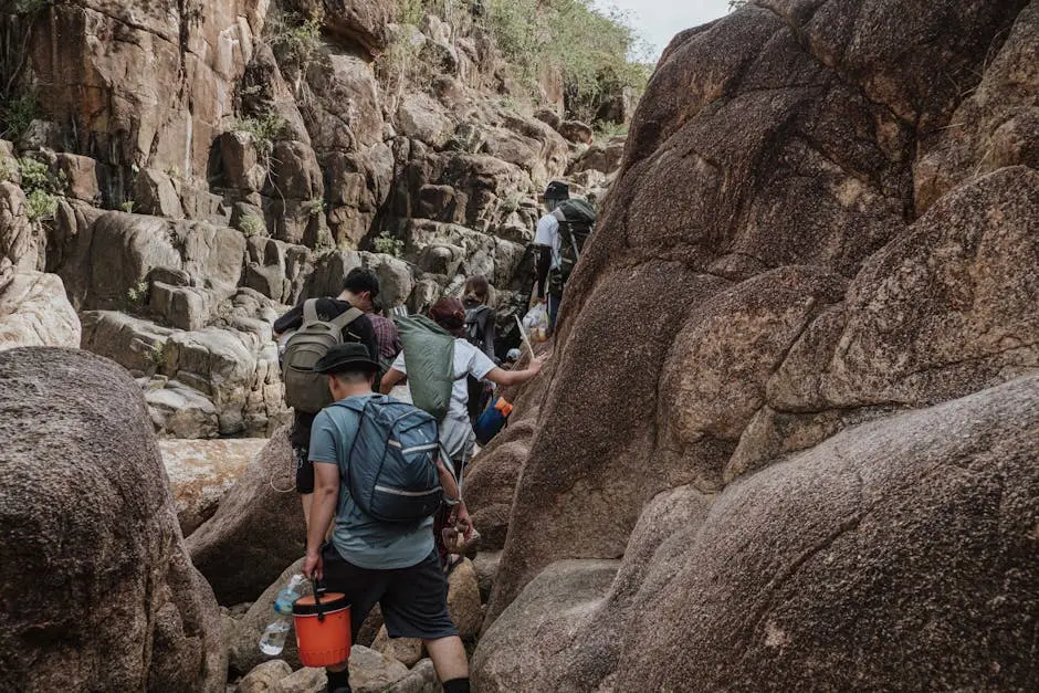 A Group Of Hikers Trekking Through Rocky Terrain Showcasing Adventure
