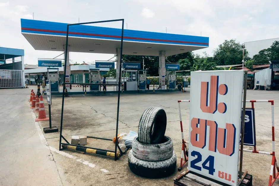 A Modern Fuel Station Featuring Gas Pumps And A Tire Repair Service Si