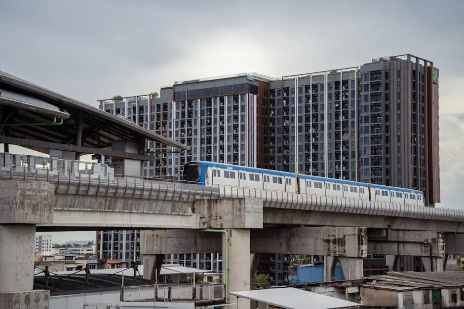 A Sky Train Glides Past A Modern Condominium Complex In Bangkok Thaila