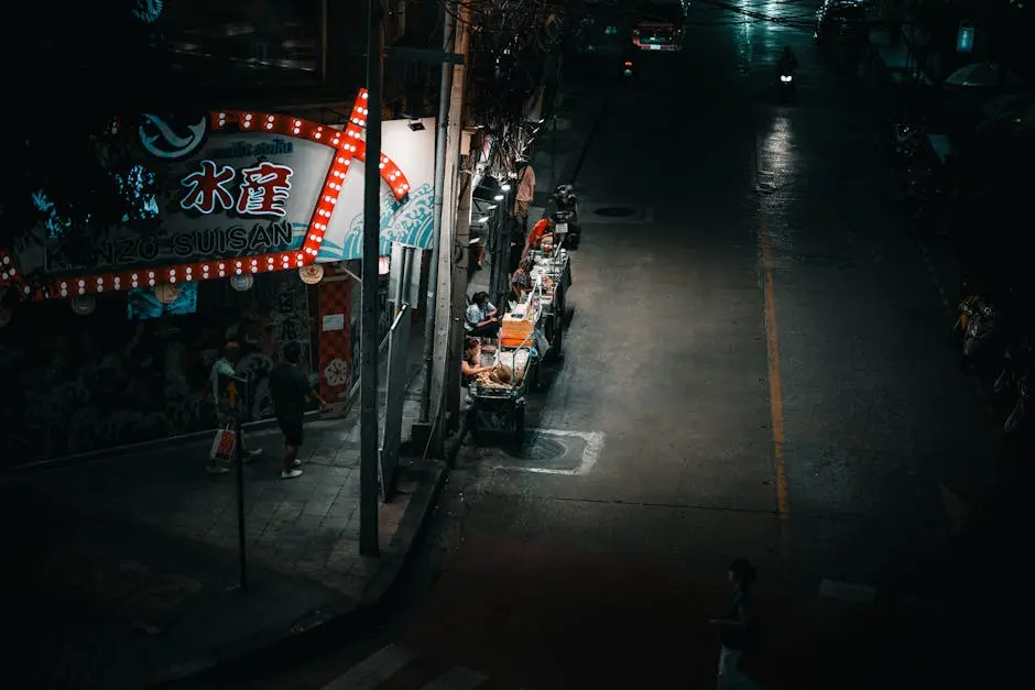 A Vibrant Street Food Stall Illuminated At Night In Bangkok Thailand W