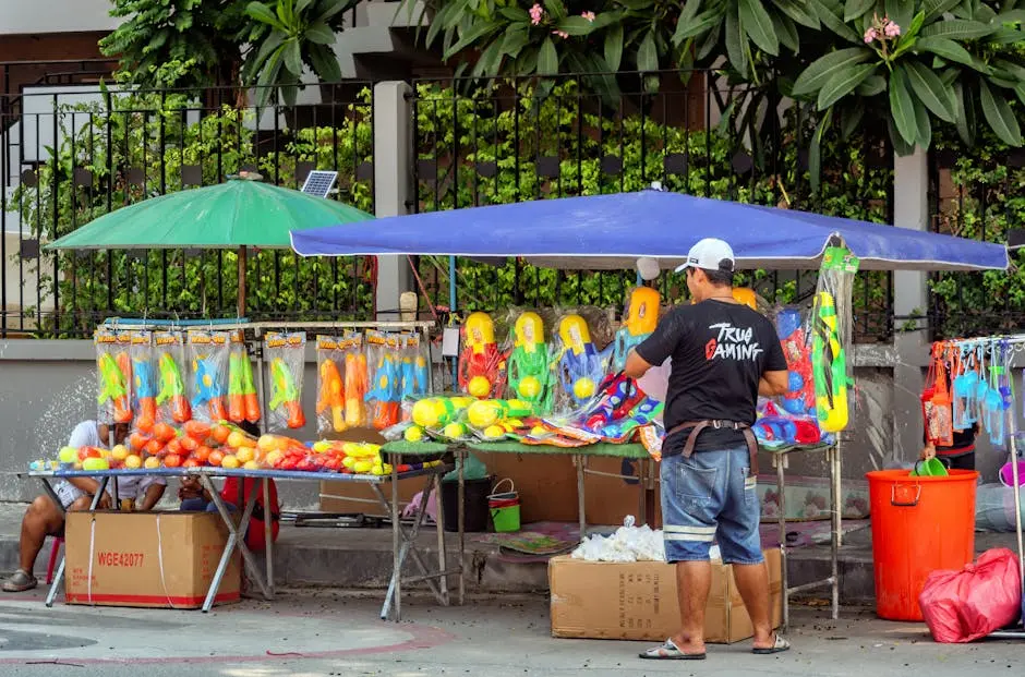 A Vibrant Street Stall Selling Colorful Water Guns In Pattaya For The