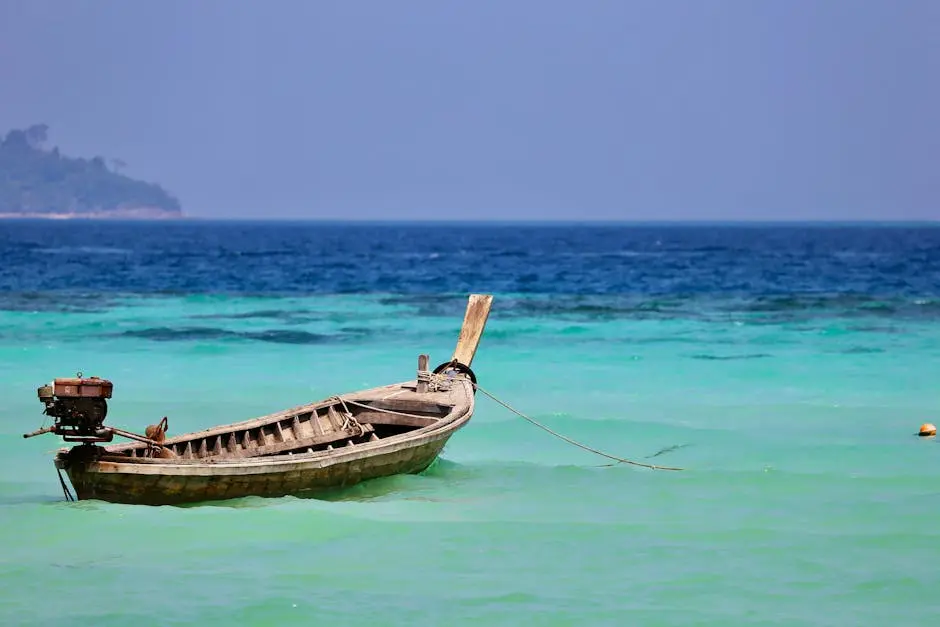 A Wooden Longtail Boat Floating On Phuket S Vibrant Turquoise Sea Unde