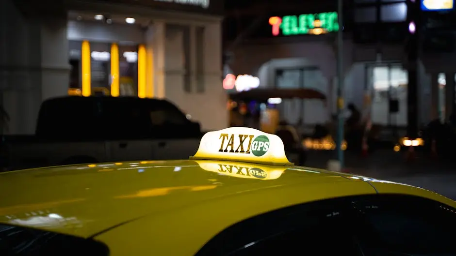 A Yellow Taxi With A Gps Sign Captured At Night In Bustling Thailand