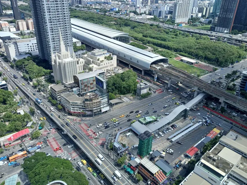 Aerial View Of A Bustling City Intersection And A Modern Train Station