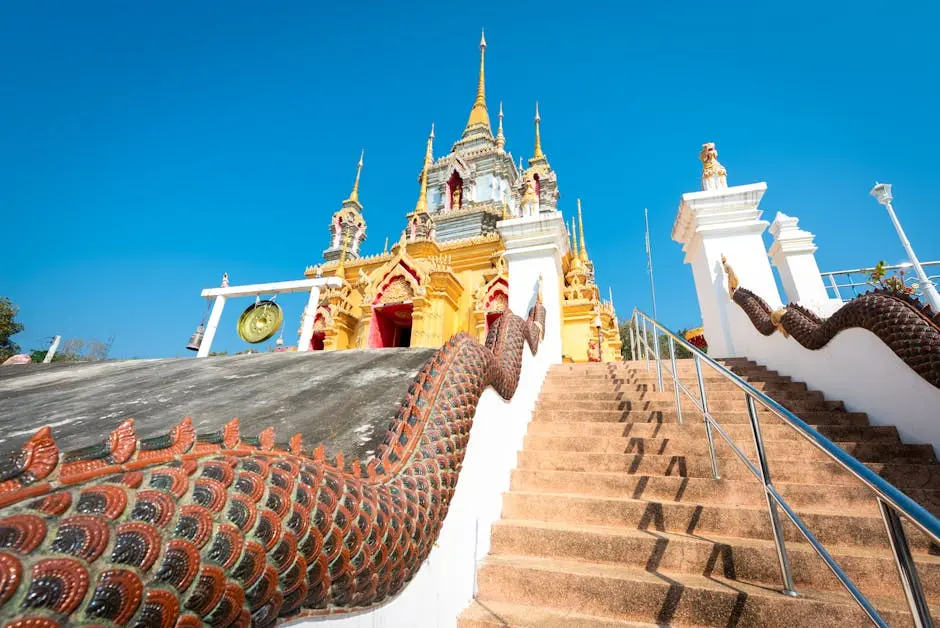 Beautiful Low Angle View Of A Colorful Thai Temple With A Serpent Stai