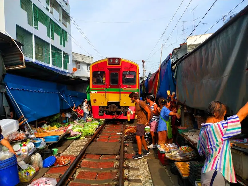 Colorful Train Passing Through Maeklong Railway Market Thailand