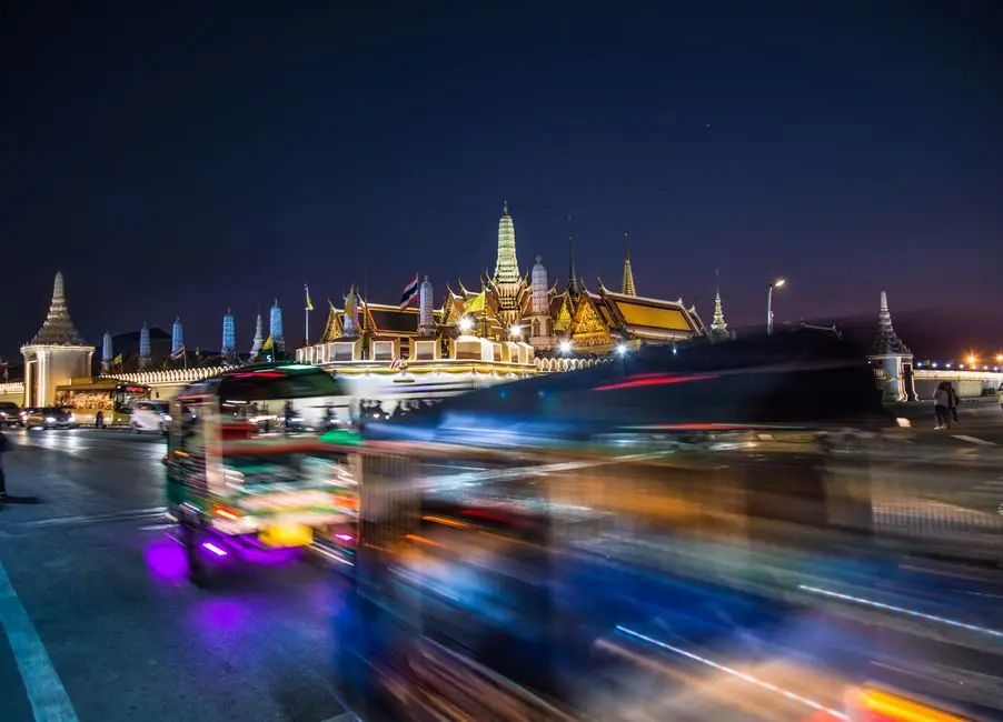 Dynamic Cityscape With Wat Phra Kaew Illuminated At Night In Bangkok T