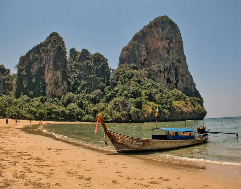 Longtail Boat Docked On The Sandy Shore Of Railay Beach With Stunning