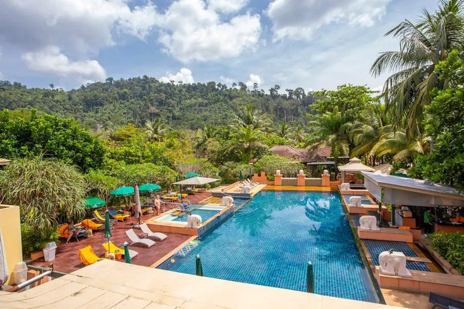 Relax By A Serene Pool At A Luxury Resort Surrounded By Tropical Natur