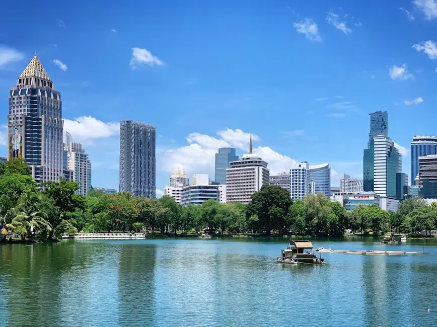 Scenic View Of Bangkok S Modern Skyline Reflecting On Lumphini Park S