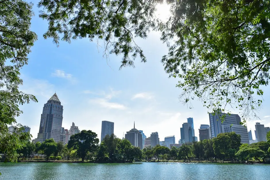 Scenic View Of Bangkok S Skyline From A Park With Lake And Trees Durin