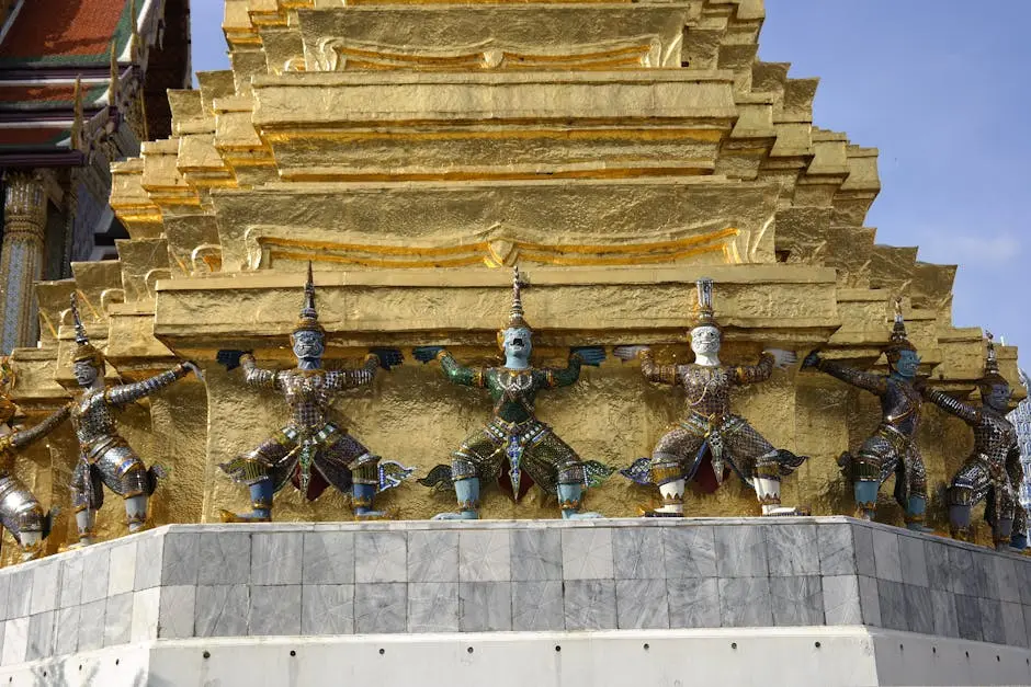 Sculpture Of Figures Holding Up A Golden Stupa At Wat Phra Kaew Bangko