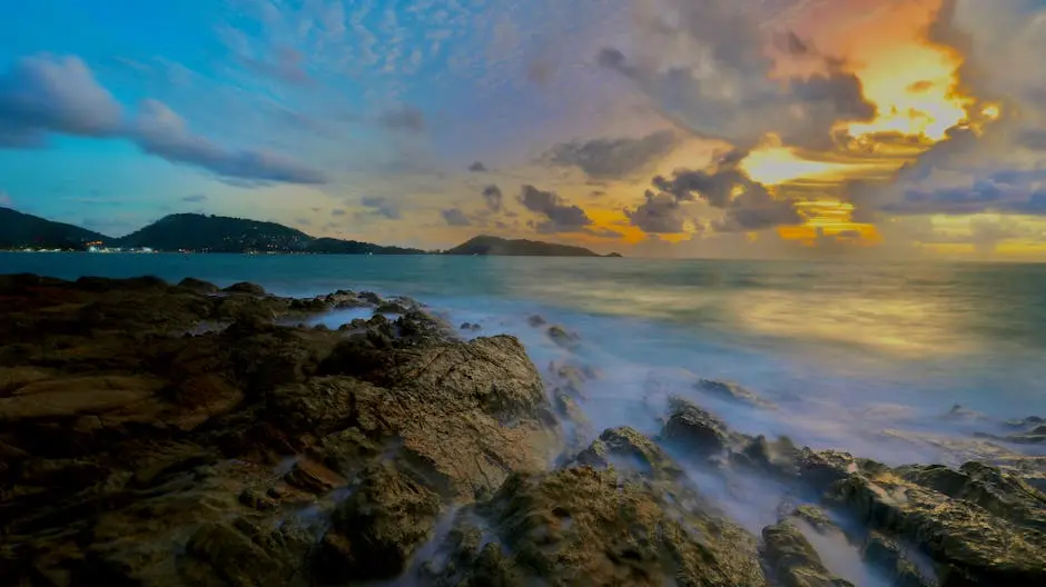 Serene View Of Sunset Over Rocky Coastline At Patong Beach Phuket Thai