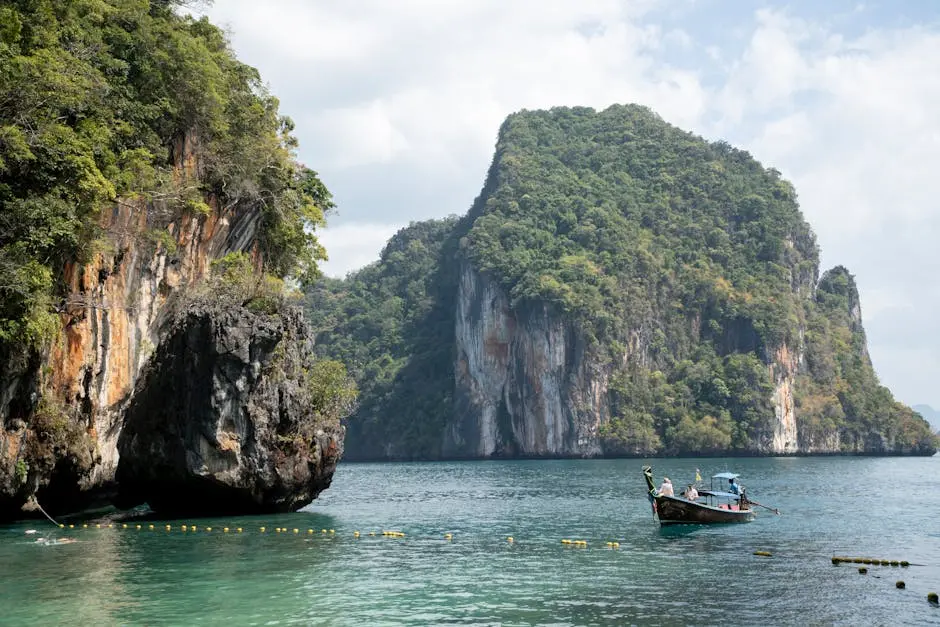 Spectacular Limestone Cliffs With A Traditional Boat In Krabi Thailand