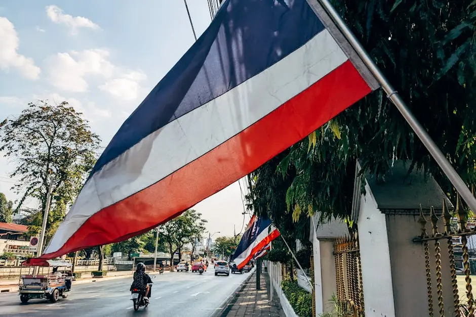 Street Scene In Thailand With Flags Lining The Road Showcasing Local C