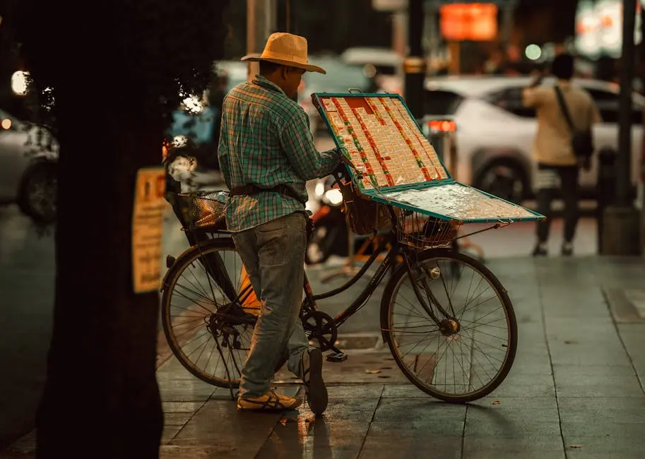 Street Vendor In Bangkok With A Bicycle Selling Lottery Tickets In The