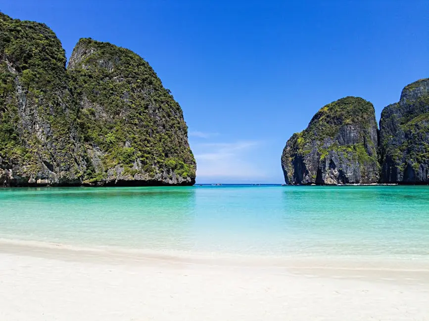 Stunning View Of Maya Bay With Turquoise Water White Sand And Lush Cli