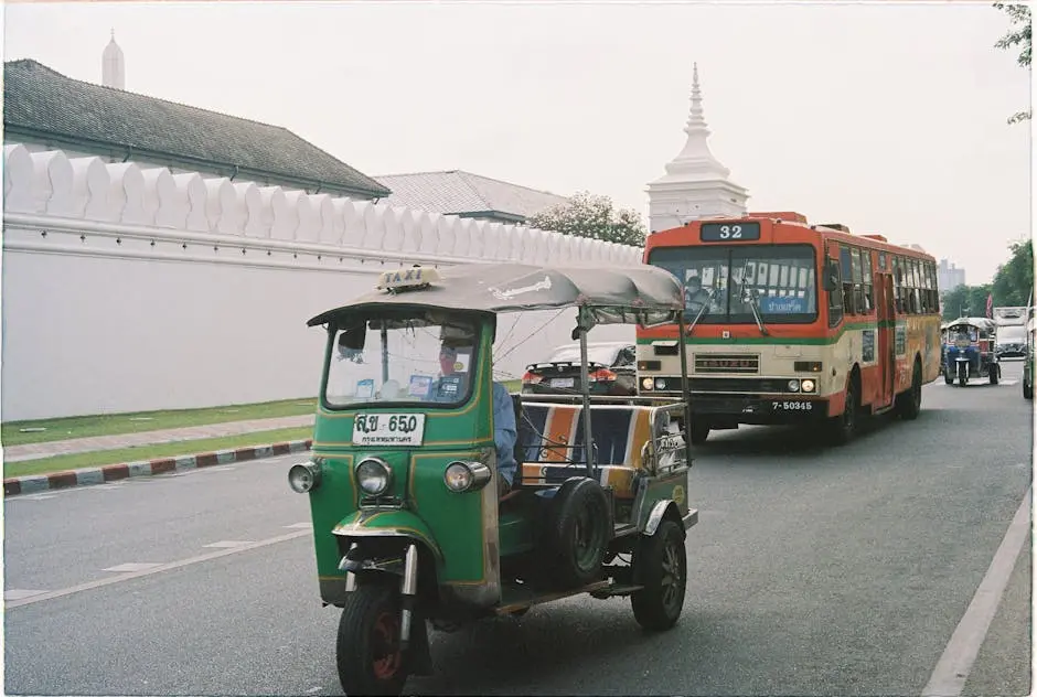 Traditional Tuk Tuk And Bus On A Vibrant Street In Bangkok Thailand