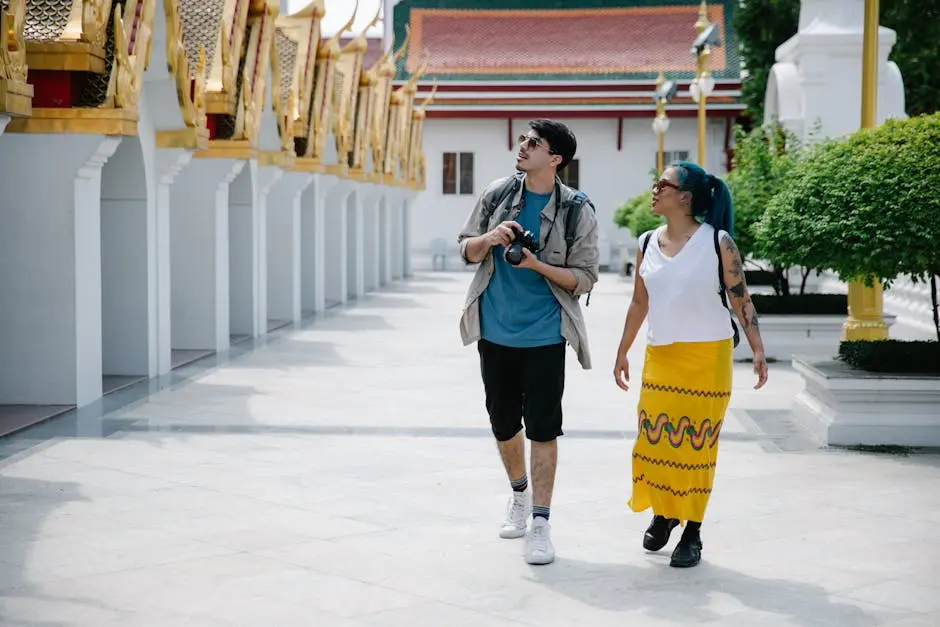 Two Tourists Walk And Explore A Traditional Thai Temple Enjoying Sight