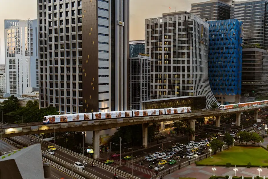 Vibrant Bangkok Cityscape Featuring Illuminated Skyscrapers And A Pass