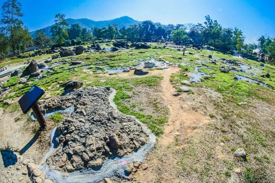Vibrant Landscape Featuring Natural Hot Springs With Rocks And Green P