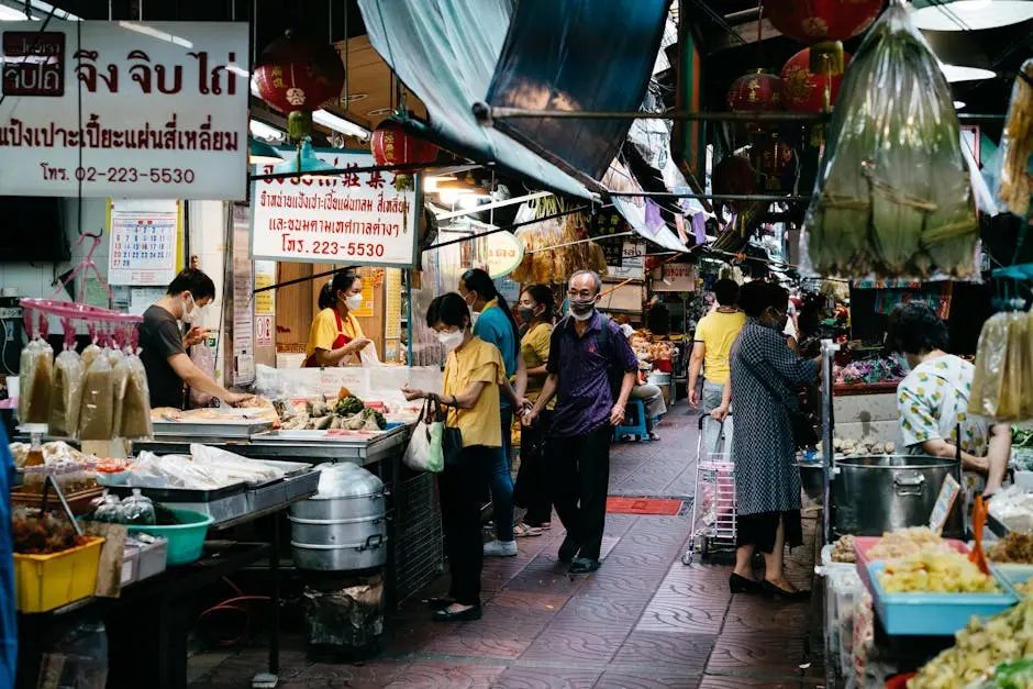 Vibrant Scene Of A Thai Street Market With People Shopping For Fresh P