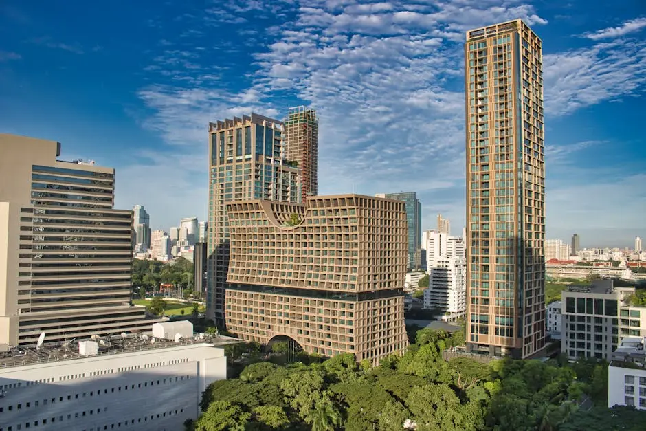 Vibrant View Of Bangkok Skyline Featuring Modern Architecture And Lush