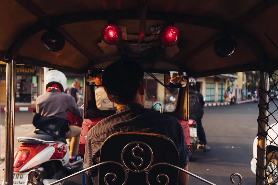 View From A Tuk Tuk In Bangkok Amidst Motorcycle Traffic At Sunset