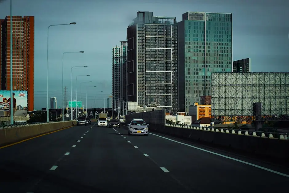 View Of A Bustling Bangkok Highway Lined With Modern Skyscrapers