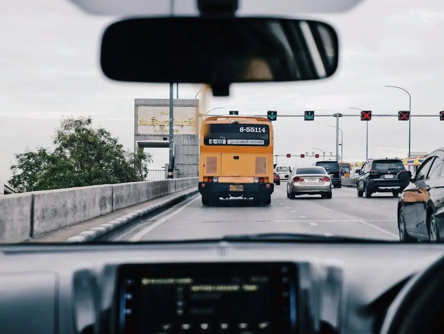 View Of Bangkok Traffic From Inside A Car Featuring Buses Cars And Roa