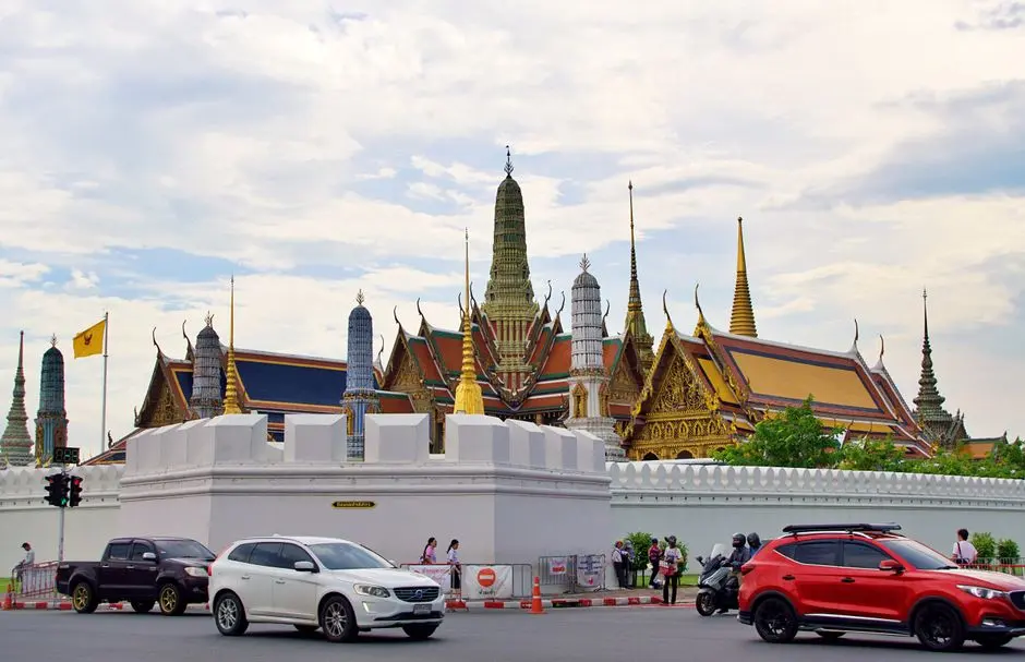 View Of The Grand Palace In Bangkok Thailand With Street Traffic In Th