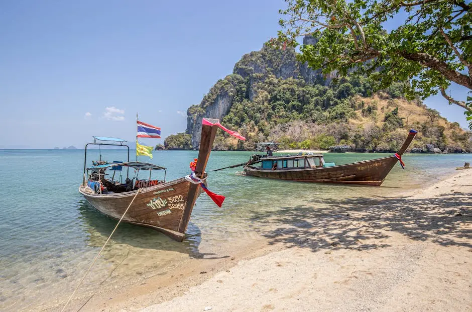 Wooden Longtail Boats Docked Under Clear Skies At Ao Nang Beach Thaila