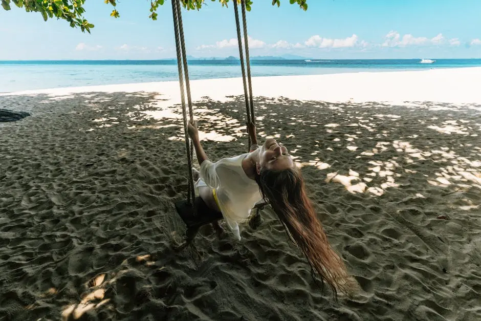Young Woman Enjoying A Swing On A Tropical Beach In Krabi Thailand