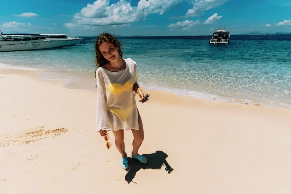 Young Woman In Yellow Bikini On Sunny Ao Nang Beach Thailand With Boat